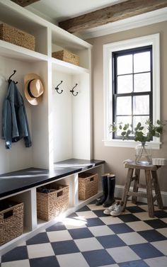 a checkered floor in a white and black entryway with coat rack, stools, and window