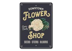 a sign that says flower shop seeds, stems and blooms on it's black background