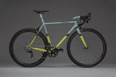 a blue and yellow bike is shown against a gray background