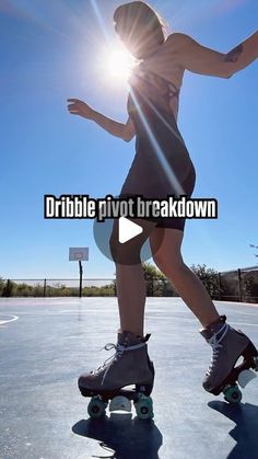 a woman riding a skateboard on top of a parking lot next to a basketball court