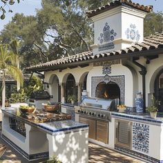 an outdoor kitchen with blue and white tiles