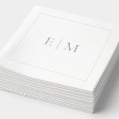 stack of folded white paper with the word em printed on it