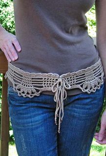 a woman is wearing a crochet belt with her hands in her pockets,