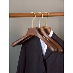 a suit and tie hanger on a coat rack