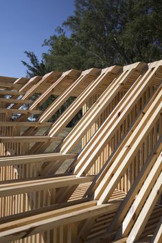 many wooden planks are stacked on top of each other