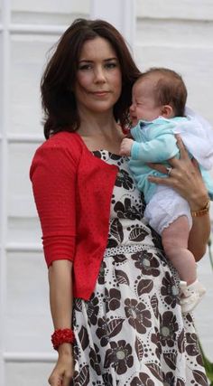 a woman holding a baby in her arms