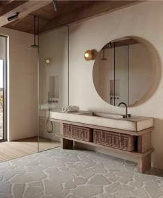 a bathroom with a sink and mirror in it's center wall, next to a large window