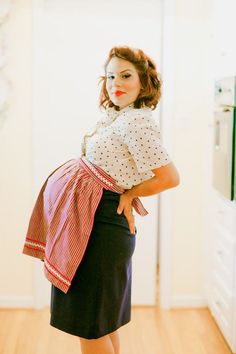 a woman is standing in the middle of a room with her hands on her hips