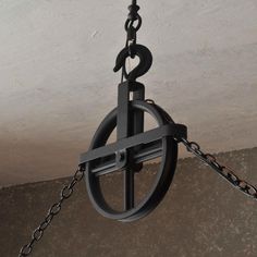 a clock hanging from a chain on the ceiling