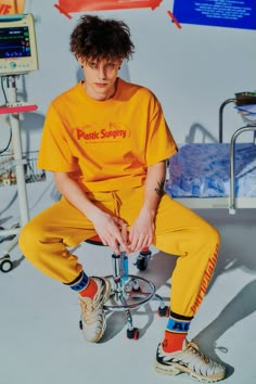 a man sitting on top of a bike in a room with lots of medical equipment