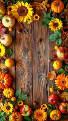 an arrangement of autumn fruits and vegetables arranged in a wreath on a wooden background with sunflowers, apples, pumpkins and pine cones