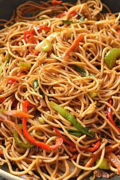 a pan filled with noodles and peppers