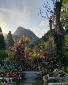 an outdoor garden with colorful flowers and trees