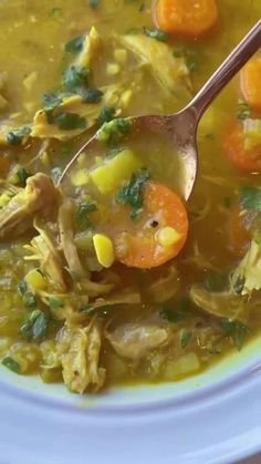 a white bowl filled with soup and carrots