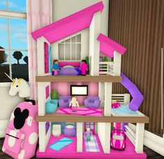 a doll house with pink furniture and accessories