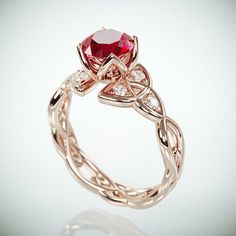 a close up view of a ring with a red stone in it's center