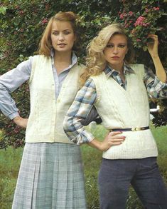 two young women standing next to each other in front of trees and bushes with their hands on their hips