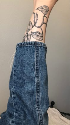 a person's arm with a flower tattoo on it, and the bottom part of their leg