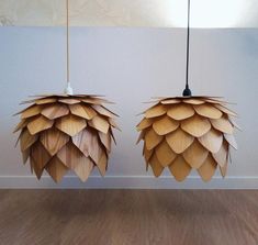 two lamps made out of wood sitting on top of a hard wood floor