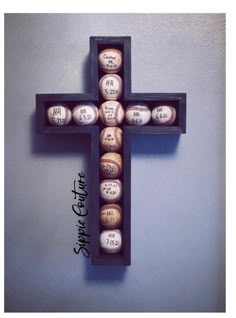 a wooden cross with baseballs in it