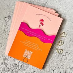 three pink and orange greeting cards on top of each other