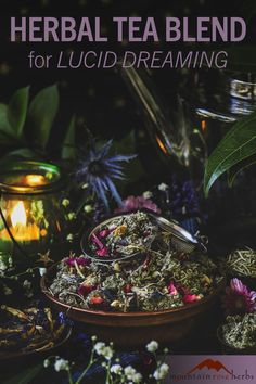 a bowl filled with flowers and herbs next to a tea pot on top of a table