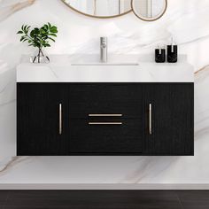 a bathroom vanity with two mirrors above it and a plant on the counter next to it