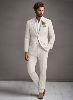 a man in a white suit and brown shoes