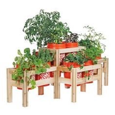 several wooden planters filled with plants on top of each other