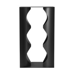 a black vase sitting on top of a white wall next to a metal stand with two wavy shapes