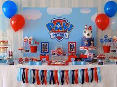 a table topped with lots of red, white and blue desserts next to balloons