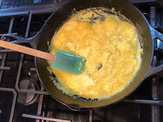 an omelet is being cooked on the stove with a spatula in it