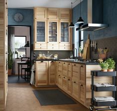 a kitchen with blue walls and wooden cabinets