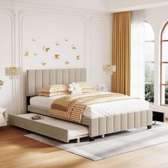 a bedroom with a bed, dressers and windows in it's center area