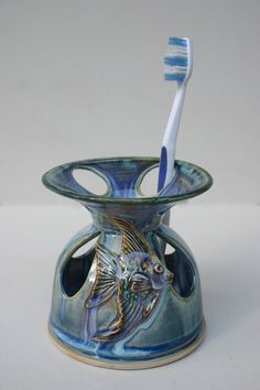 a toothbrush holder with a fish on it