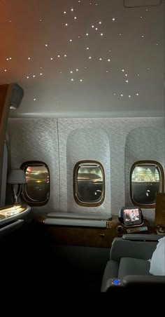 the inside of an airplane with two windows and some lights on it's ceiling