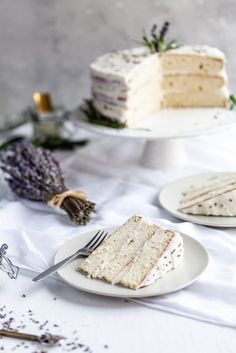 three slices of cake on plates with lavender sprinkles next to the cake