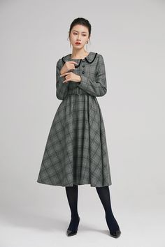 "Simple. With its pleated skirt and grayscale plaid pattern, this vintage wool dress epitomizes classic styling. She's all class and quality with no bells or whistles. Near-perfect vintage condition, designed with lapel collar, long sleeves and tie belt waist, it will be your favorite one of your wardrobe. Details: * 35% wool blend, 35% fiber and polyester, 30% nylon * Polyester lining * long sleeves * tie belt waist * lapel collar * button decoration in front * knee length * back zipper closure Vintage Plaid Dress For Fall, Classic Vintage Dress For Work In Fall, Classic Vintage Dress For Fall Workwear, Classic Fall Vintage Dress For Workwear, Winter Plaid Long Sleeve Dress, Long Sleeve Plaid Dress For Winter, Vintage Plaid Winter Dress, Retro Plaid Winter Dresses, Vintage Plaid Dress For Winter