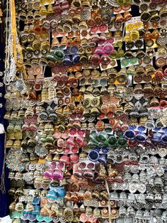 many different types of rings and necklaces on display