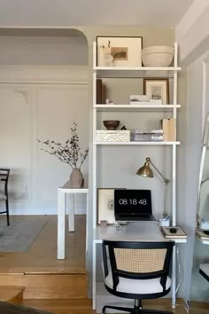 a room with a chair, desk and shelves