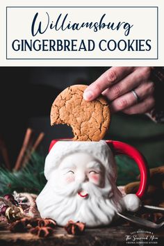 a cookie being dunked into a mug filled with gingerbread cookies for santa's day