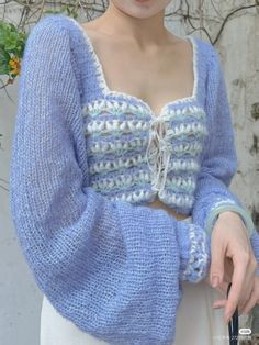 a woman wearing a blue and white knitted sweater