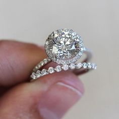 a person holding a diamond ring in their hand