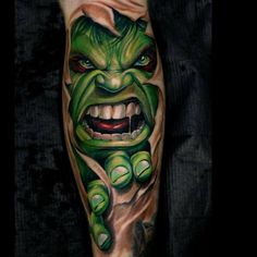 a man's leg with a green monster tattoo on it