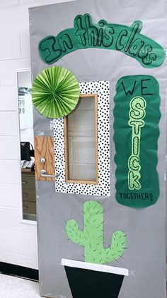 a classroom door decorated with green and white decorations