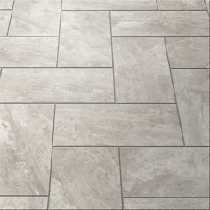 a tile floor that is made out of grey marble tiles and has an irregular pattern