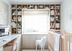 a baby's room with a crib and shelves filled with toys, bookshelves and stuffed animals