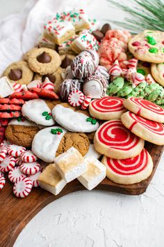 a wooden platter filled with cookies and candy