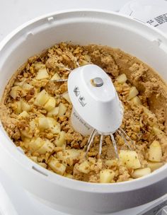 a food processor is filled with some kind of fruit and breadcrumbs in it