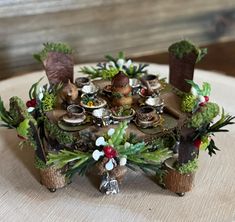 a table topped with lots of different types of food and plants on top of it